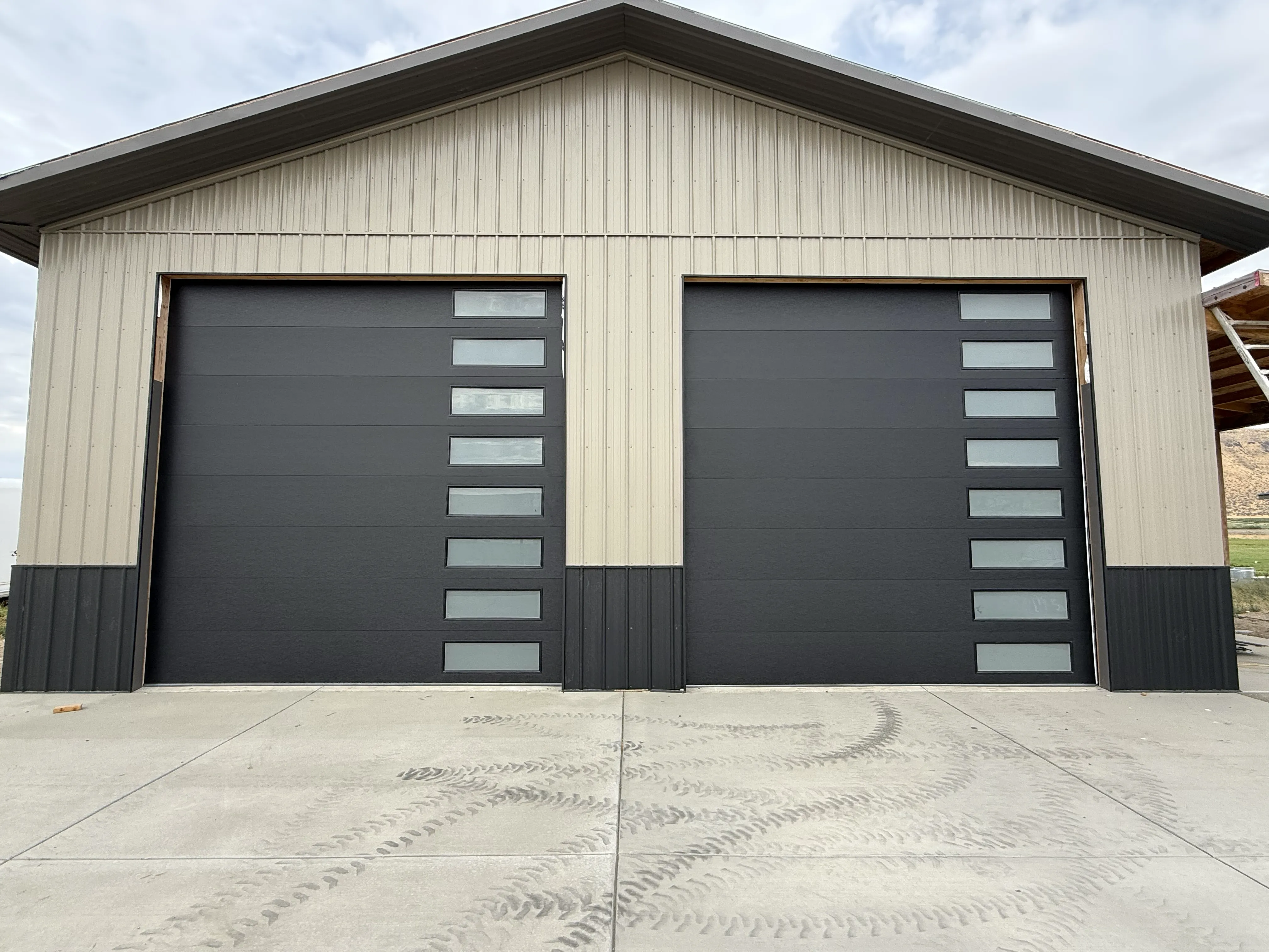 commercial garage door flush design with windows on the right side black color