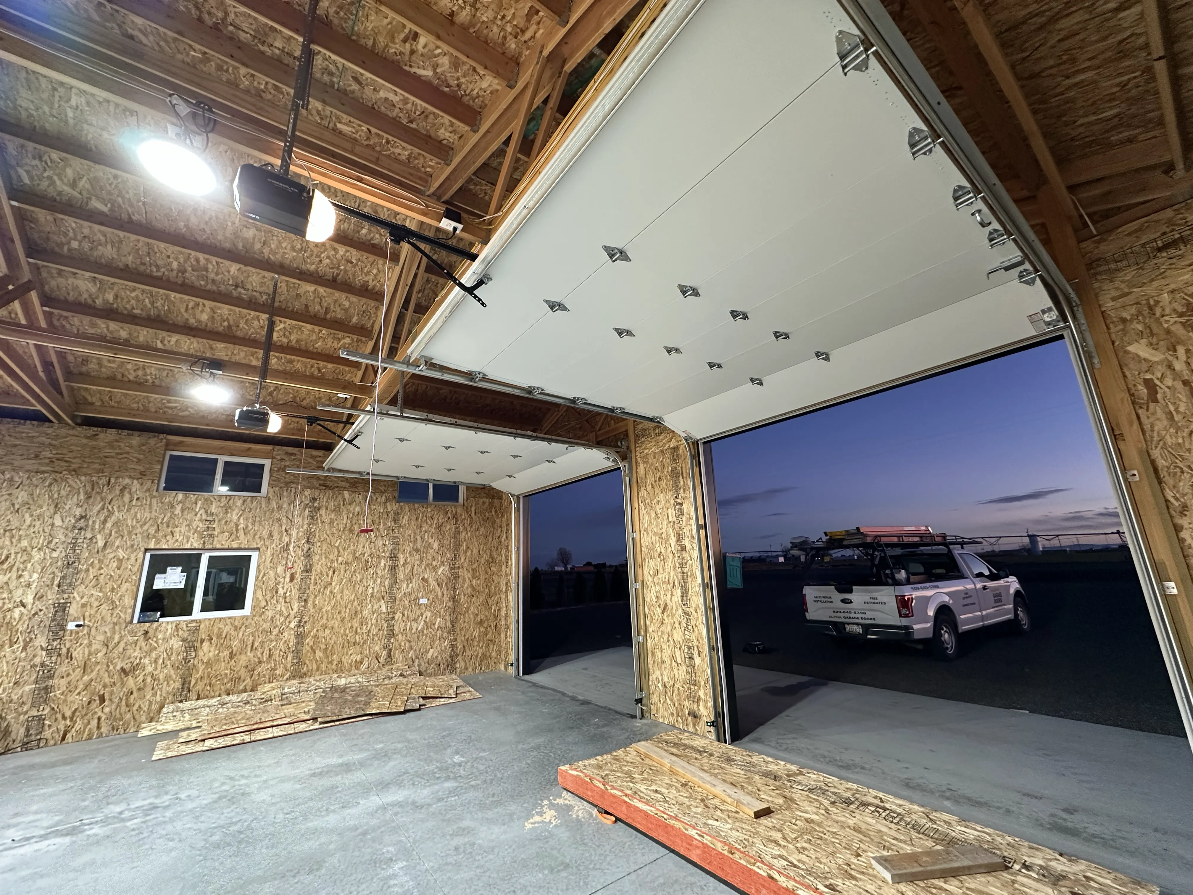 Garage door opener installation in progress at night